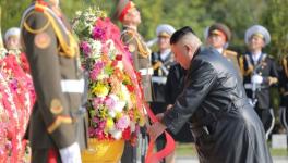 North Korean leader Kim Jong Un (R) placing wreath at monument to martyrs of Chinese People’s Volunteer Army who fought in Korean War.