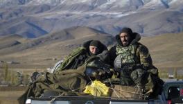 Armenian soldiers ride a car passing the border between Nagorno-Karabakh and Armenia near Vardenis, Sunday, Nov. 8, 2020.