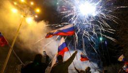 People wave Russian national flags celebrating Moscow’s recognition Donetsk and Lugansk, eastern Ukraine, Feb 21, 2022