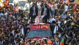 Varanasi, Mar 04 (ANI): Prime Minister Narendra Modi waves to the BJP supporters during a roadshow in support of party candidate for the seventh and last phase of Uttar Pradesh Assembly elections, in Varanasi on Friday.