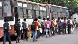 Migrants labor go by foot to their home after arriving from the special train due to unavailability of transport