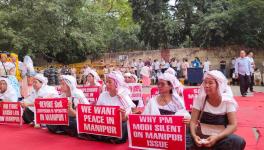 The members of the Joint Coordinating Committee for Peace of Imphal-based Khwairamband Ima Keithel protest at New Delhi’s Jantar Mantar on Monday.