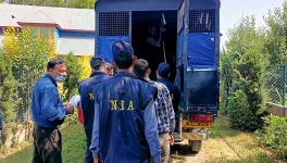 National Investigation Agency (NIA) sleuths during the installation of 'notice' mentioning the attachment of properties of businessman Zahoor Ahmad Shah Watali in connection with a terror funding case, in Kupwara, Monday, June 12, 2023. 