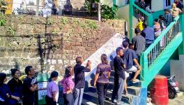 Voters wait in a queue to cast their votes for Mizoram Assembly elections, in Aizawl, Tuesday, Nov. 7, 2023.