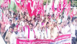 Trade union members try to break the police barricade at Madha Koil junction, in Puducherry, on Tuesday. Image credit: Theekkathir.