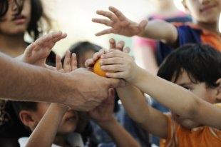 Humanitarian food for poor children in refugee camp  Photo Credit: Zurijeta/Shutterstock