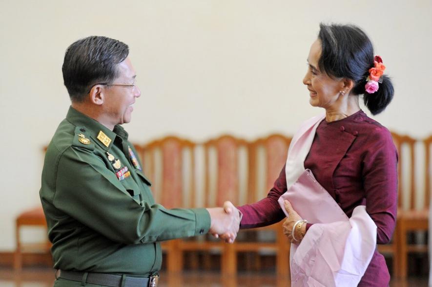 n this file photo dated Dec. 2, 2015 Myanmar military chief General Min Aung Hlaing (L) and National League for Democracy party leader Aung San Suu Kyi (R) shake hands after their meeting at the Commander-in-Chief's office in Naypyidaw.