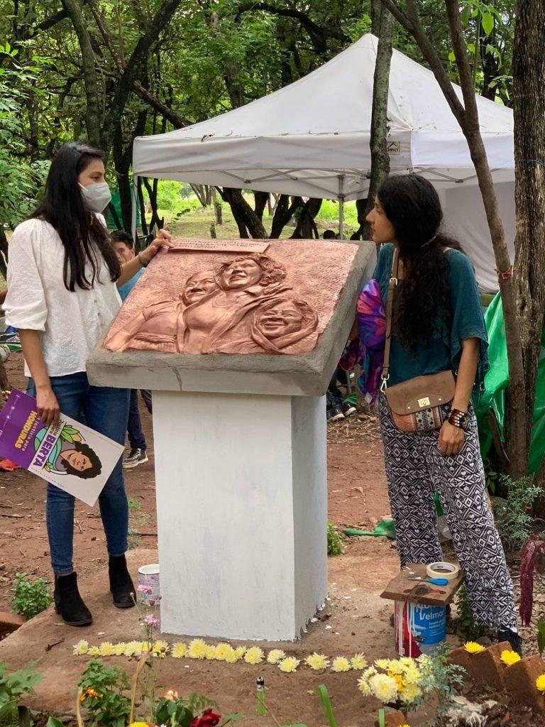 Bertha and Laura Zúniga installed a plaque showing their mother Berta Cáceres in the area where the feminist camp was held during the trial. Photo: COPINH