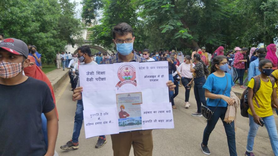 A student with a placard at the protest site.