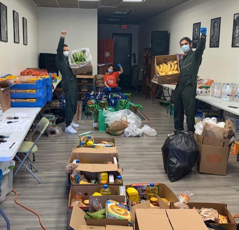 US Program volunteers pose with boxes while packing up groceries for distribution. Photo: Philadelphia Liberation Center