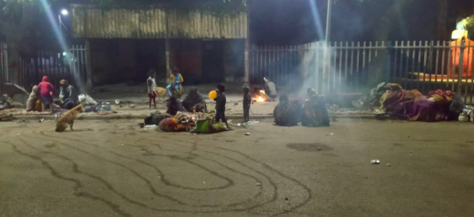  few families living on the sidewalk at night