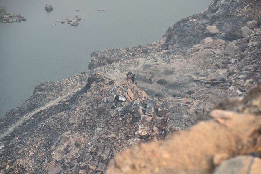 Locals scraping loose coal from the non-operational Rajapur Open Cast Mine to sell in the open market 