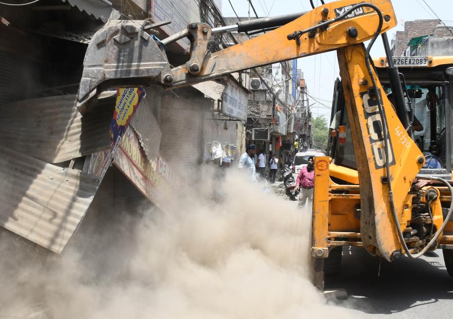 The author searches for meanings in the symbol of a bulldozer as they are unleashed on the streets of India to demolish all in their path.