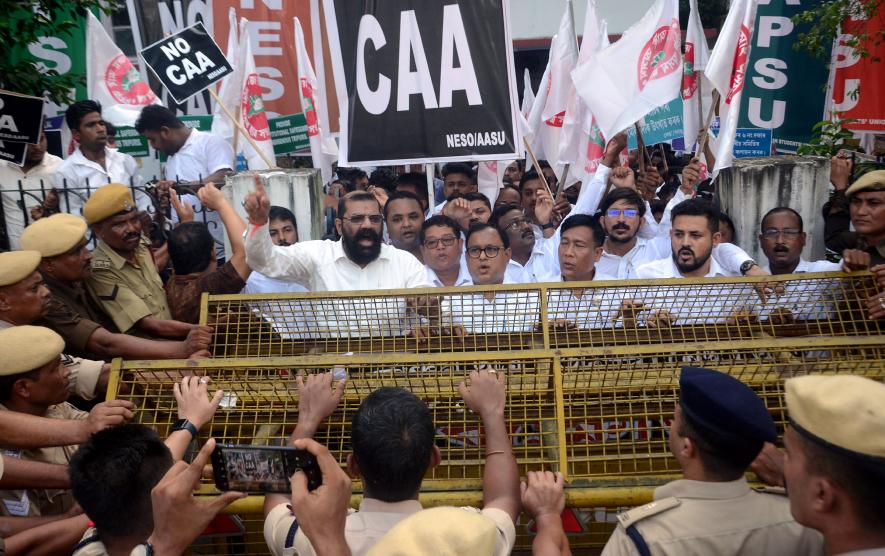 Police personnel stand guard as North-East Students Organisation (NESO) leaders and supporters stage a protest demanding scrapping of the Citizenship Amendment Act (CAA), in Guwahati.