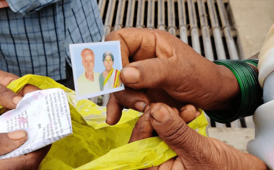 Lakshmakka shows a photo of her late husband, Gurumurthy