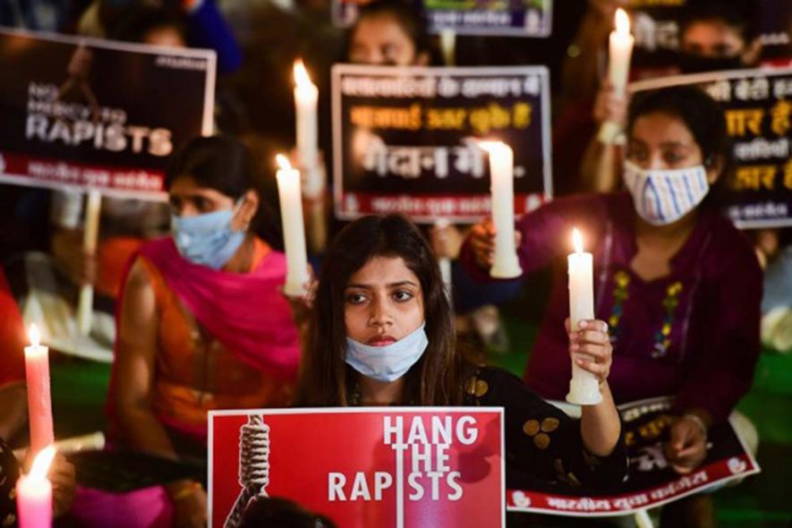 Women hold a candlelight vigil demanding justice for Hathras victim, in New Delhi. PTI File Photo