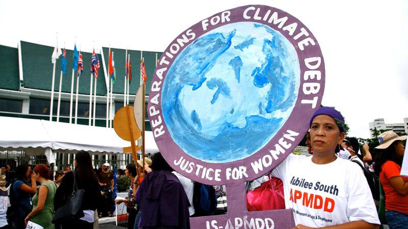 Rather than recognizing and paying a clear climate debt, we expend energy negotiating a loss and damage regime to be packaged as a humanitarian gesture. (Photo via Global Justice Now)