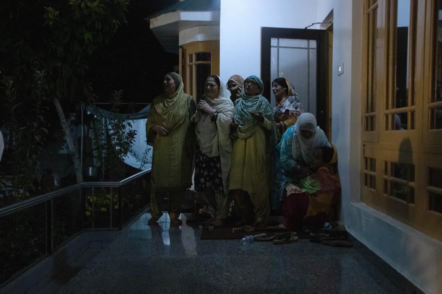 Family members of Humayun Bhat mourning at his residence