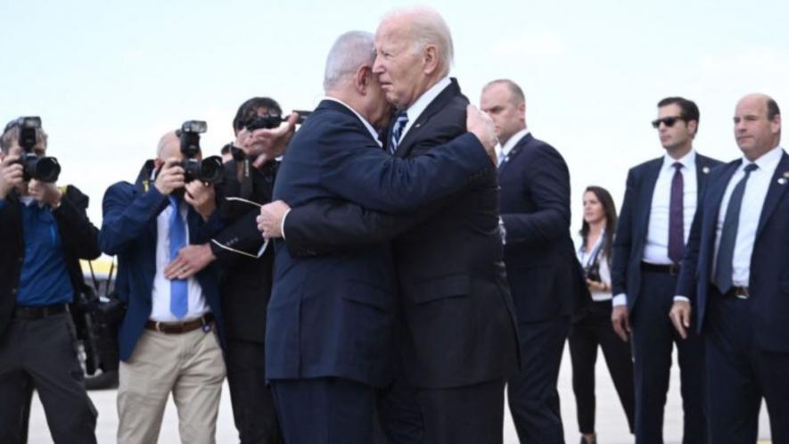 US President Joe Biden hugs Israeli PM Benjamin Netanyahu upon arrival at Tel Aviv airport, October 18, 2023