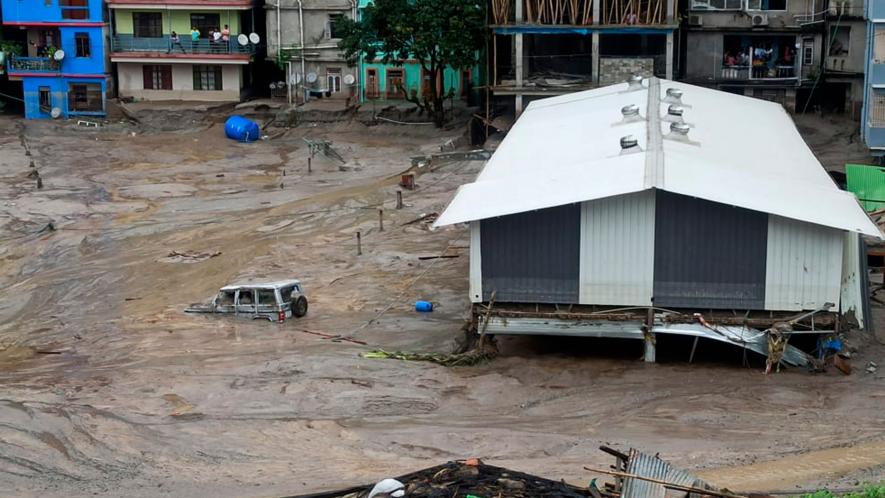 A vehicle is seen partially submerged in water after flash floods triggered by a sudden heavy rainfall swamped the Rangpo town in Sikkim, India, Thursday, Oct.5. 2023.
