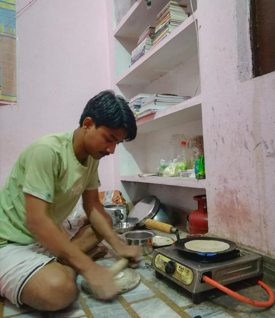 Sandeep Kumar making lunch before going to his coaching. 