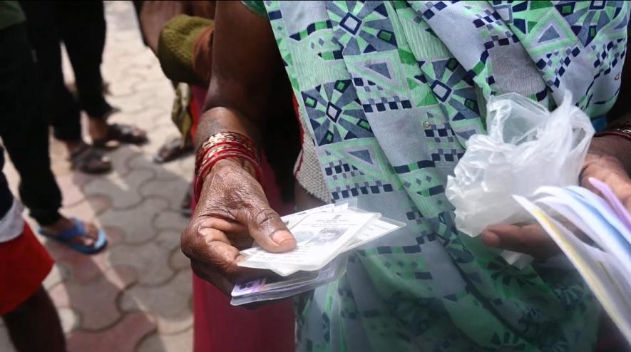 Residents with ID cards for Rehabilitation at Jailorwala Bagh Slum, Ashok Vihar, Delhi.