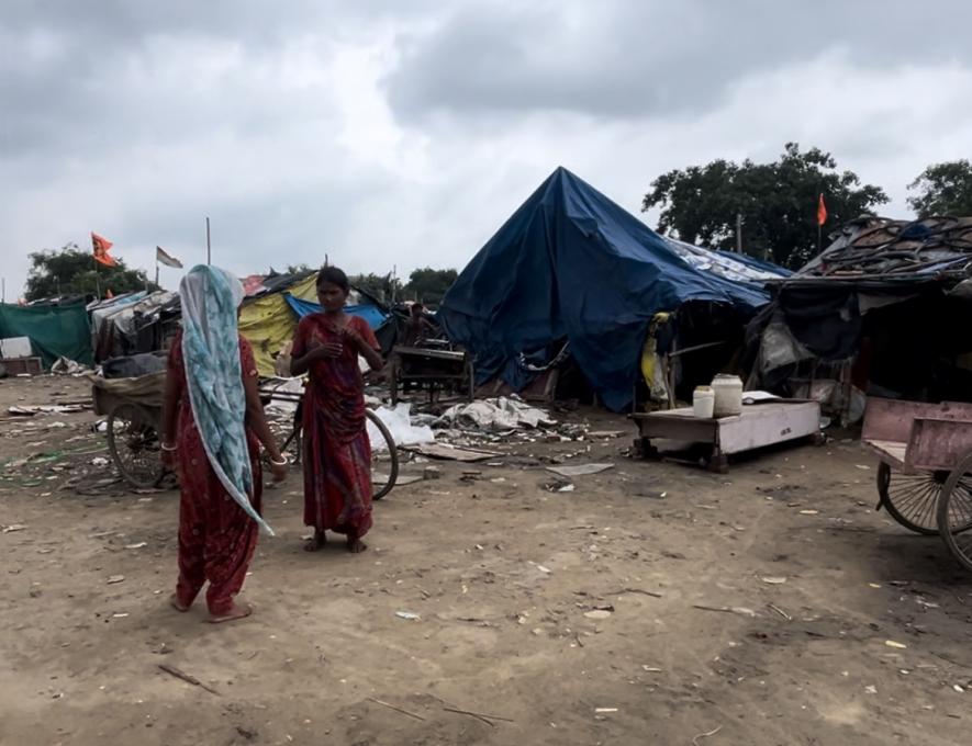 Residents of slum near Guldhar Railway Station, Ghaziabad with Ram Mandir flags on top of the dwellings in the background