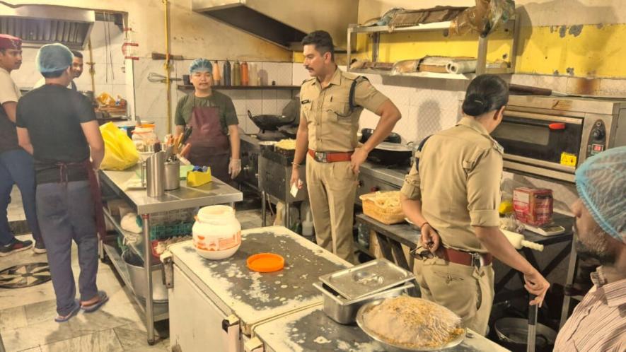 Police officials inspecting a restaurant kitchen in Dehradun on Wednesday.