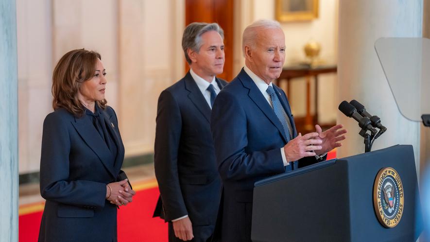 President Biden stands in front of Vice President Harris and Secretary of State Antony Blinken (Photo via @POTUS/X)