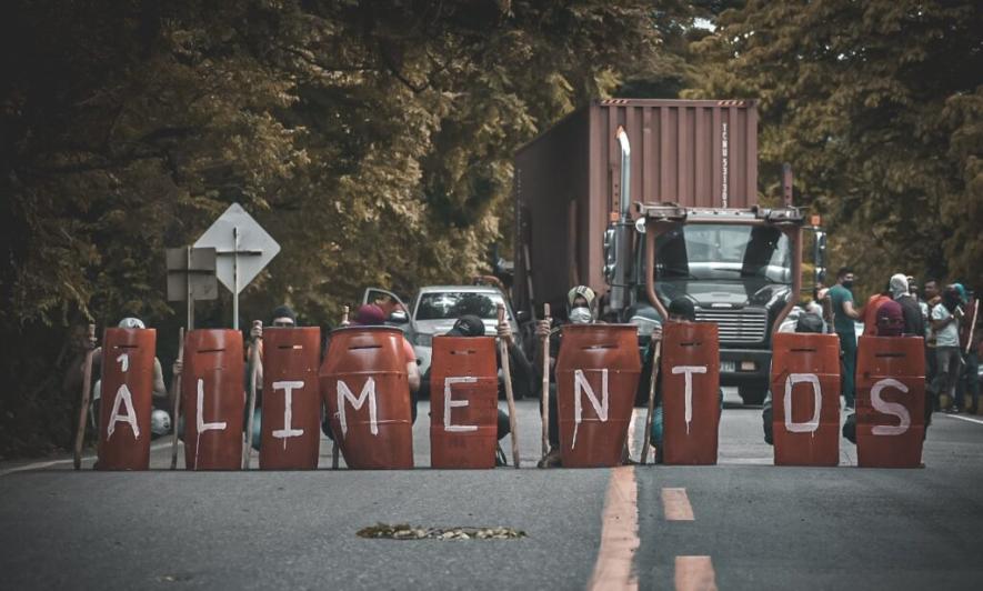 Members of CISCA blockaded one of the major highways in Colombia during the 2021 uprising against neoliberalism and the government of Iván Duque. Their shields say “food”. Photo: CISCA